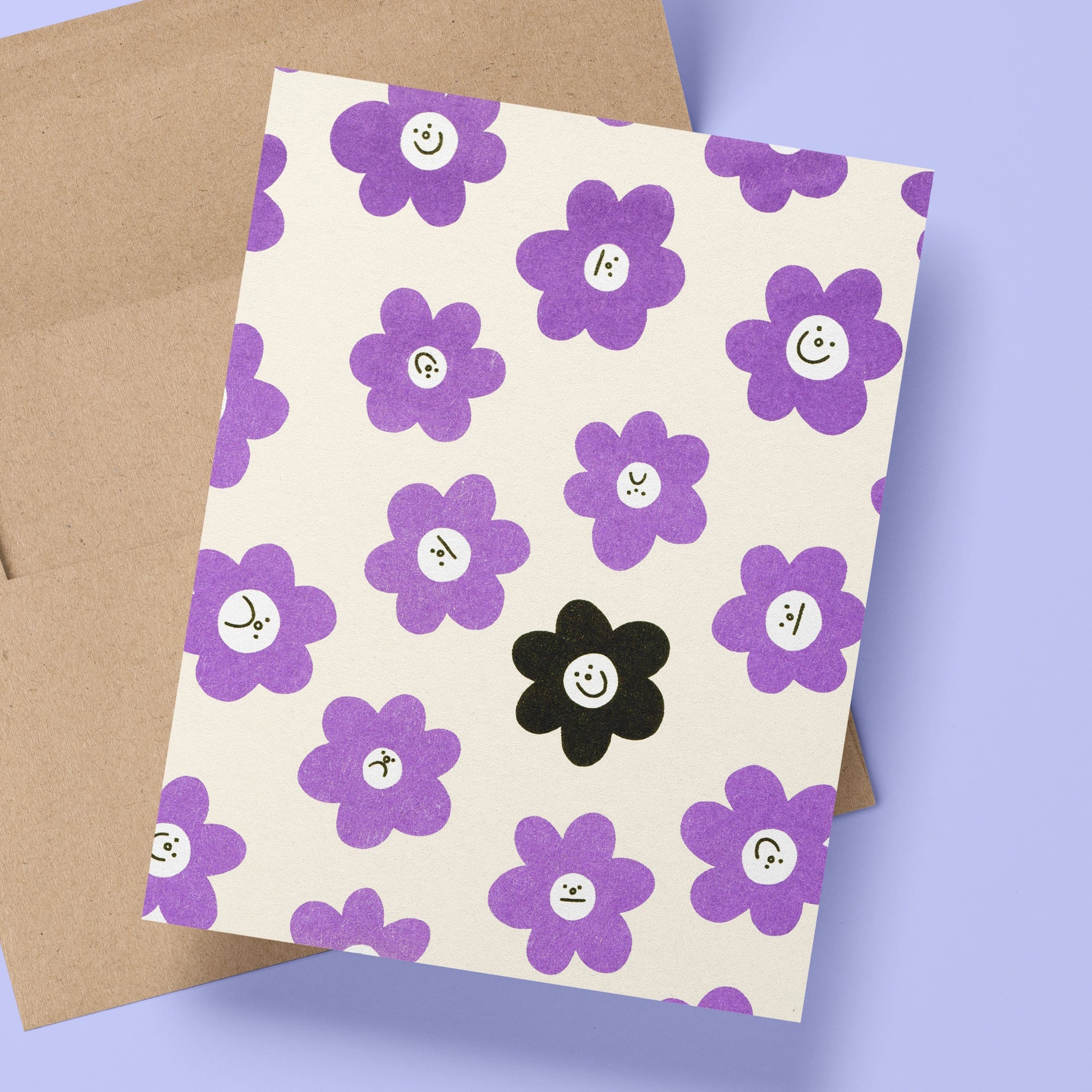 A risograph printed greeting card with kraft envelope, sits on a periwinkle background.